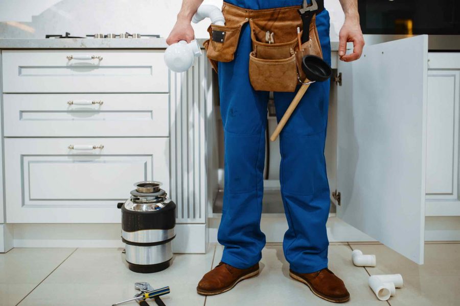 male-plumber-installing-water-filter-in-kitchen-T3GSVGW.jpg